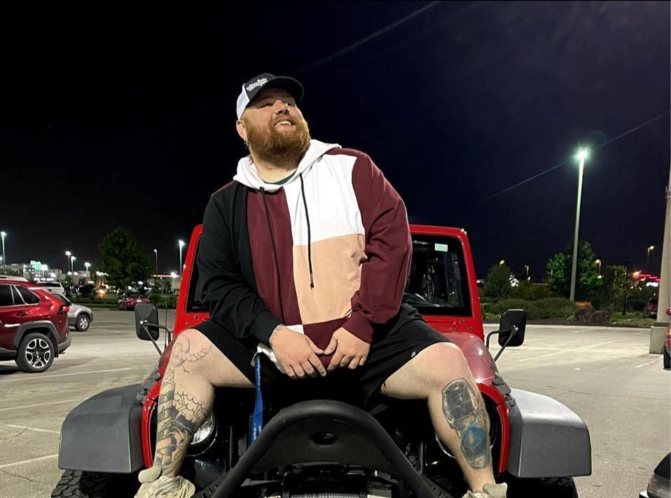 Jeremy Butner sitting on a jeep.